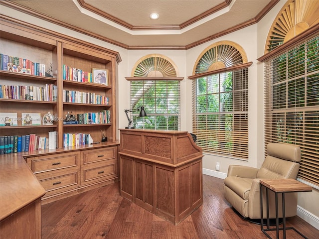 living area featuring dark hardwood / wood-style floors, a textured ceiling, and crown molding