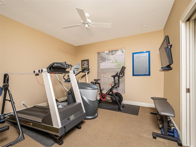 workout area with a textured ceiling, carpet flooring, and ceiling fan