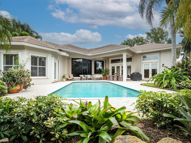 view of swimming pool with french doors and a patio area