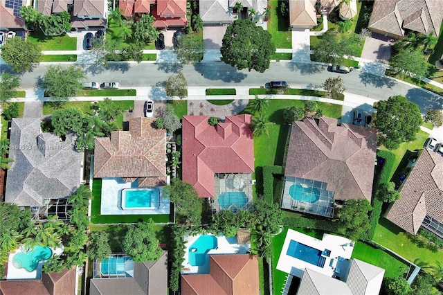 aerial overview of property's location featuring nearby suburban area and a pool