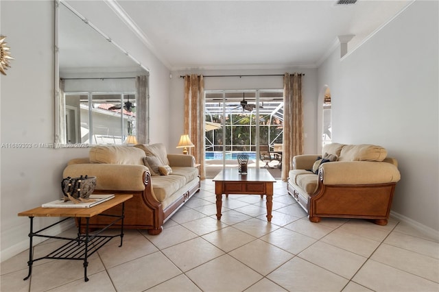 living area featuring crown molding, light tile patterned flooring, and baseboards