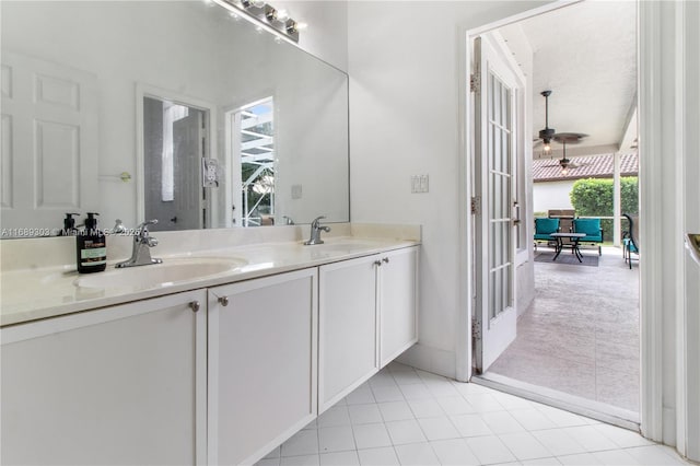 bathroom with a ceiling fan, double vanity, tile patterned flooring, and french doors