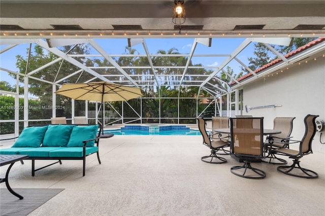 view of pool with a patio and glass enclosure