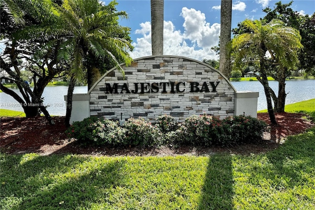 community / neighborhood sign with a water view