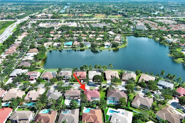 aerial view of property's location featuring a large body of water and nearby suburban area