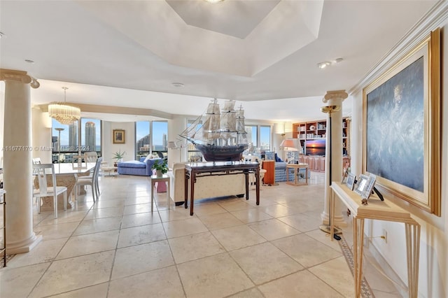 tiled dining room with plenty of natural light, a chandelier, and a raised ceiling