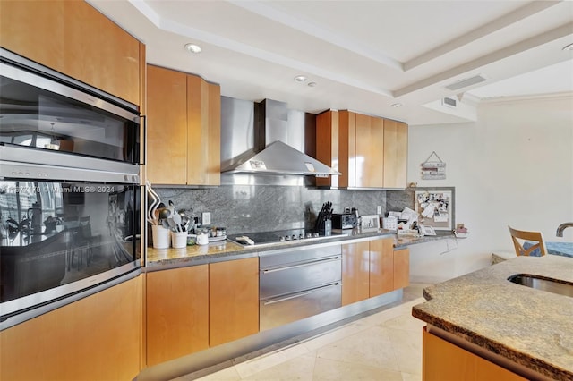 kitchen featuring decorative backsplash, wall chimney exhaust hood, sink, black stovetop, and light tile patterned flooring