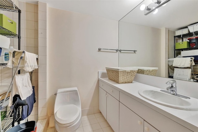 bathroom featuring vanity, tile patterned floors, and toilet