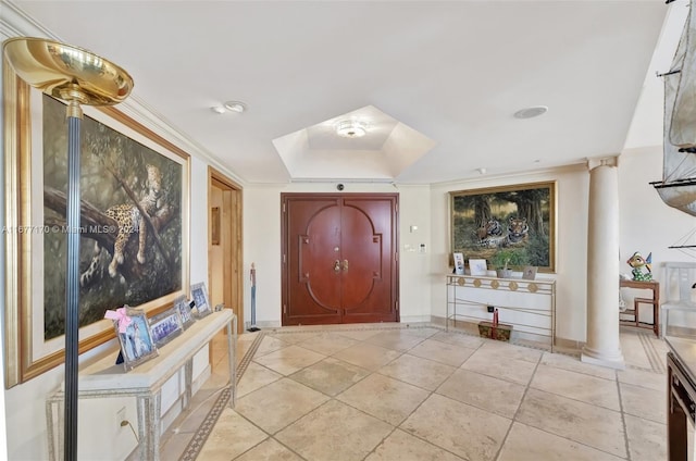 entryway featuring crown molding and decorative columns