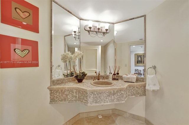 bathroom featuring a chandelier, sink, and tile patterned flooring