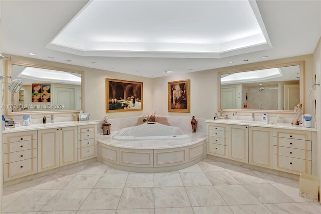 bathroom with tile patterned floors, vanity, shower with separate bathtub, and a tray ceiling