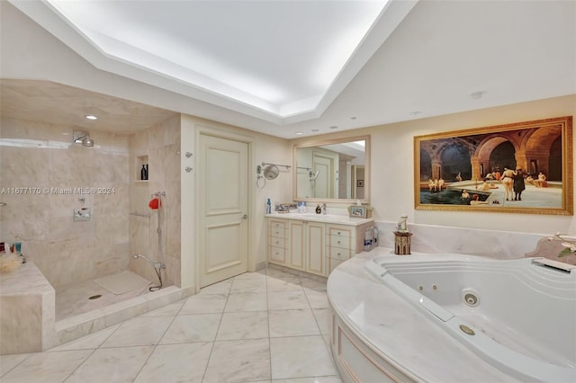 bathroom with vanity, a raised ceiling, and separate shower and tub