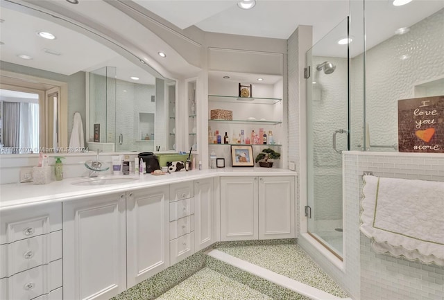 bathroom featuring vanity and an enclosed shower