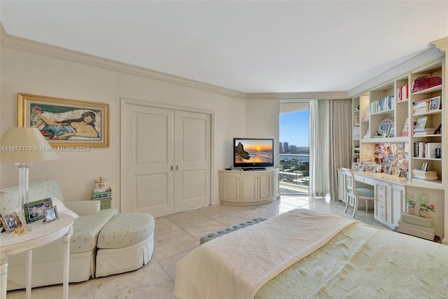 bedroom featuring light tile patterned floors, built in desk, crown molding, and a closet