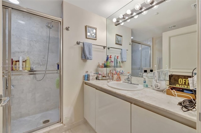 bathroom featuring vanity and a shower with door