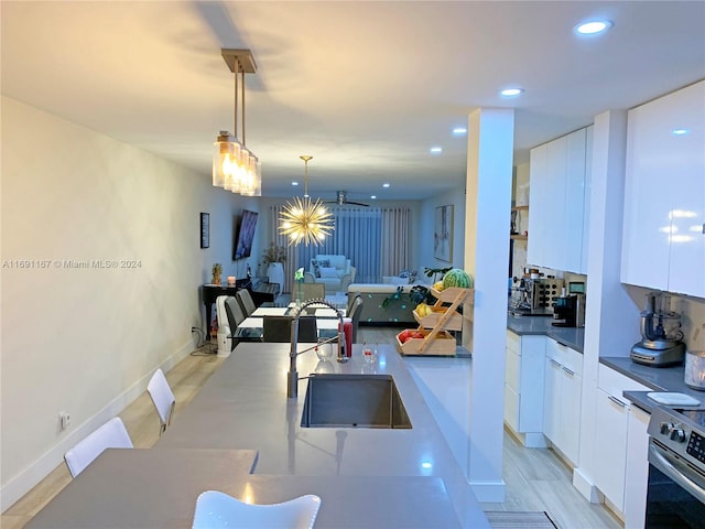 dining area featuring sink and light hardwood / wood-style flooring