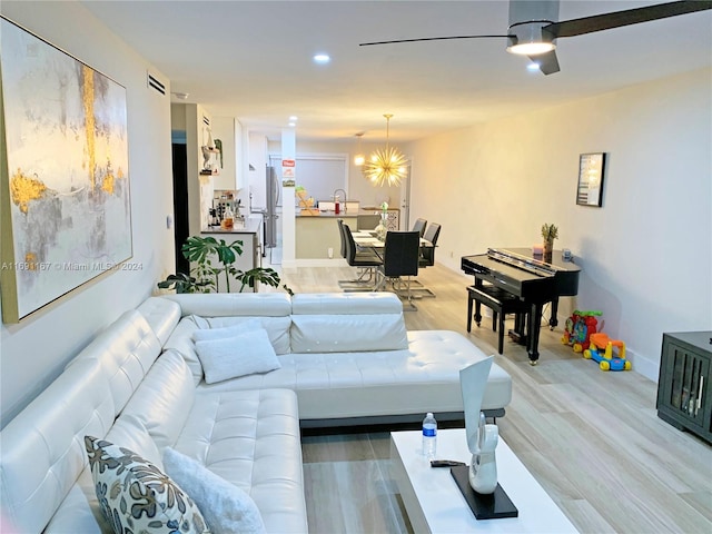 living room with a notable chandelier and wood-type flooring