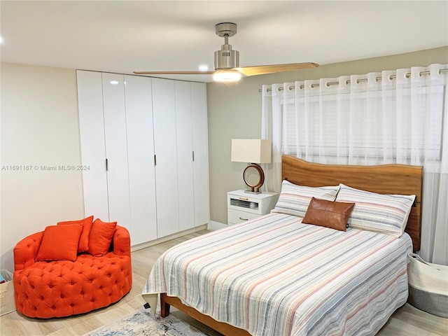 bedroom with light wood-type flooring and ceiling fan