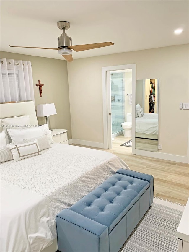 bedroom with ceiling fan, wood-type flooring, and ensuite bath