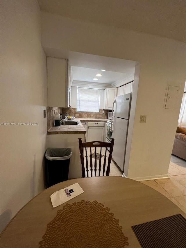 tiled dining room featuring sink