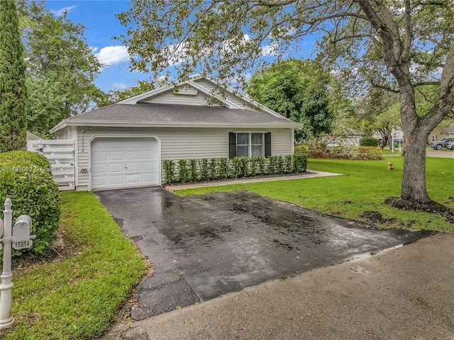 view of front of home featuring a garage and a front lawn