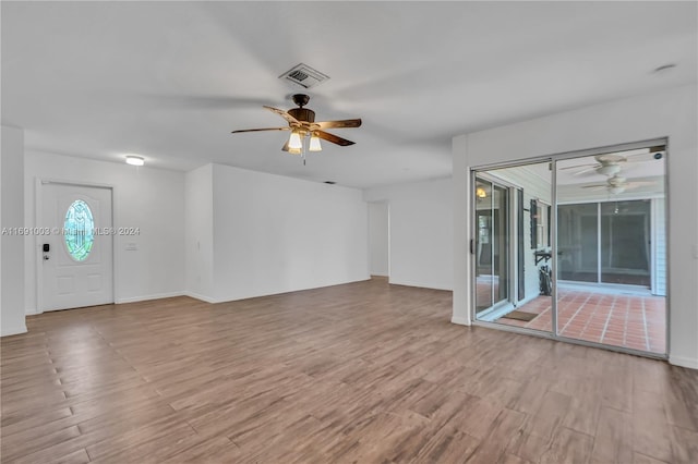 unfurnished living room featuring light hardwood / wood-style floors and ceiling fan