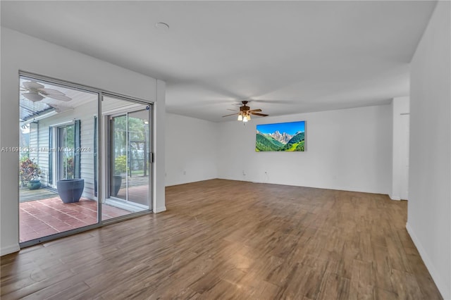 unfurnished living room featuring hardwood / wood-style floors and ceiling fan