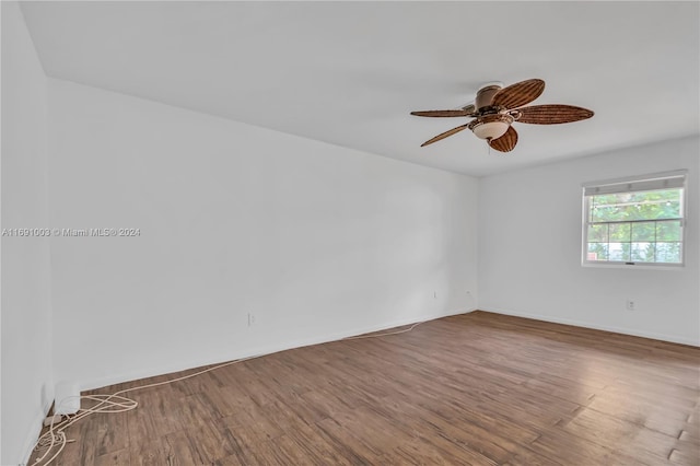 spare room with hardwood / wood-style flooring and ceiling fan