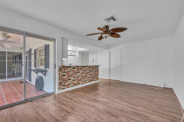 spare room with ceiling fan and wood-type flooring