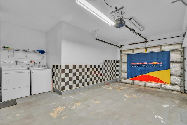 garage featuring a garage door opener and separate washer and dryer