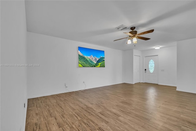 unfurnished living room with light wood-type flooring and ceiling fan