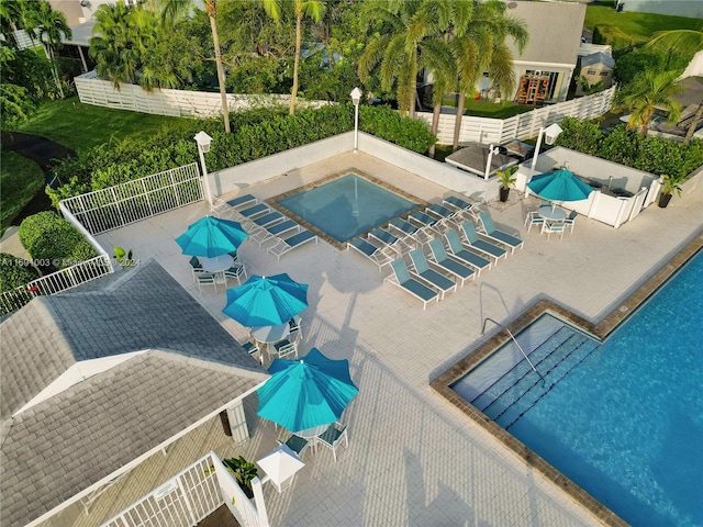 view of swimming pool with a hot tub and a patio