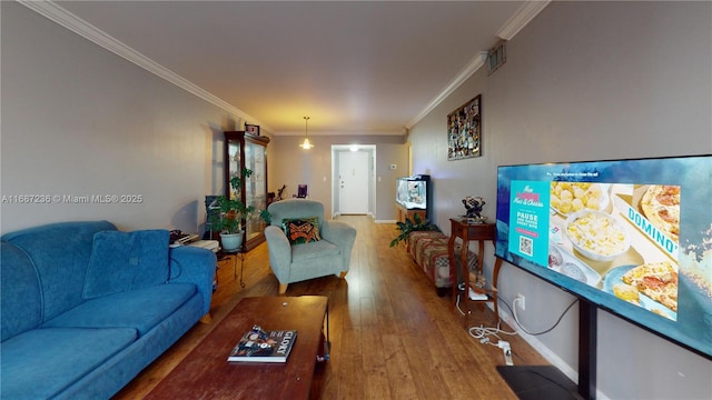 living room featuring crown molding and hardwood / wood-style flooring