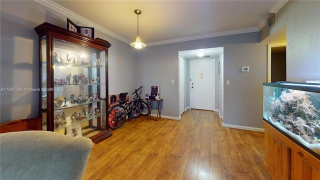 foyer entrance featuring light hardwood / wood-style flooring and ornamental molding