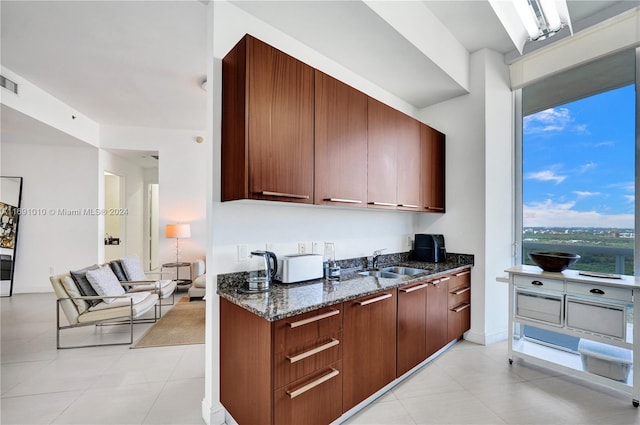 kitchen with dark stone counters and sink