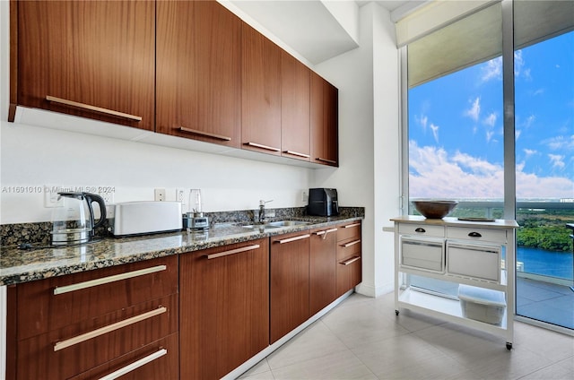 kitchen with dark stone countertops and sink