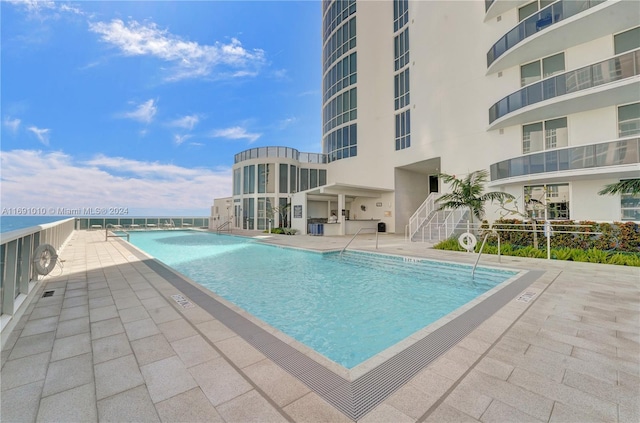 view of swimming pool featuring a patio area