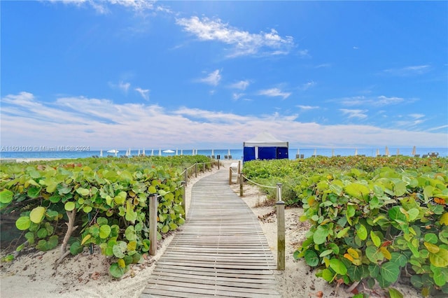 view of property's community featuring a beach view and a water view