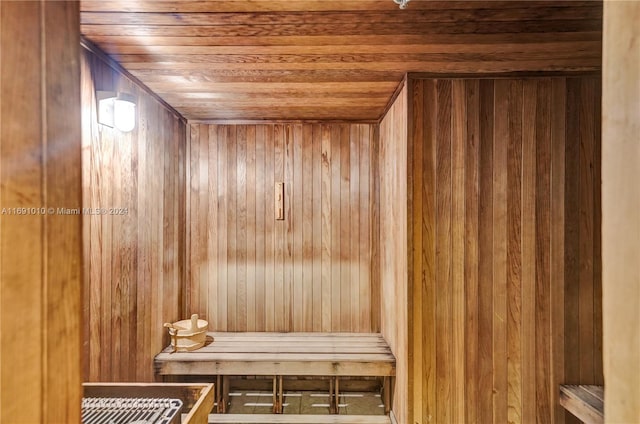 view of sauna / steam room with wooden ceiling and wood walls