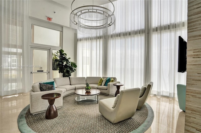 living room featuring a towering ceiling and an inviting chandelier