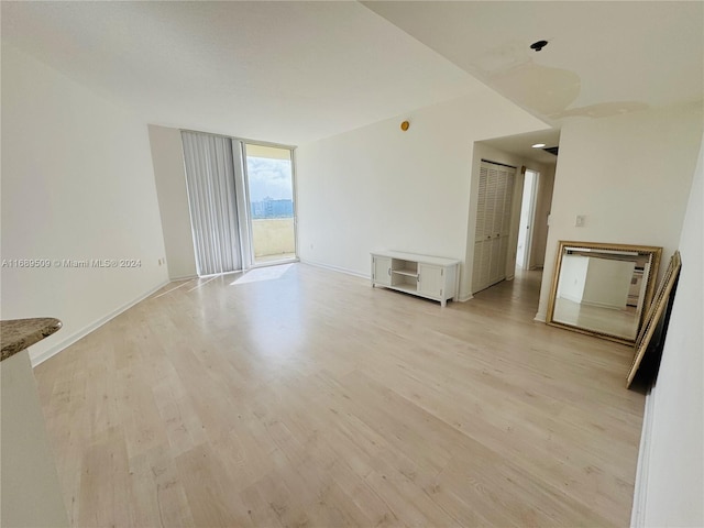 empty room with light hardwood / wood-style floors