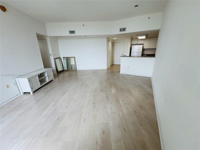 unfurnished living room with light hardwood / wood-style flooring