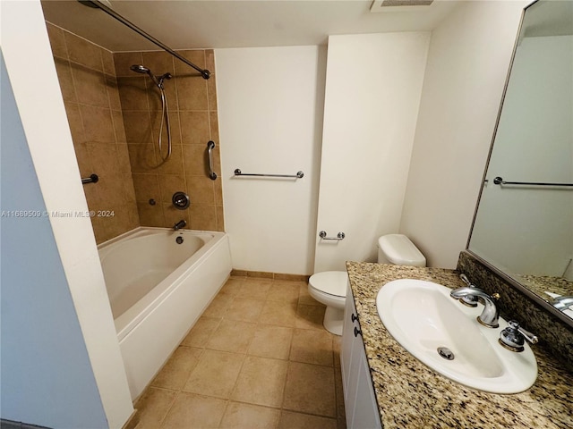 full bathroom with toilet, tiled shower / bath combo, vanity, and tile patterned flooring