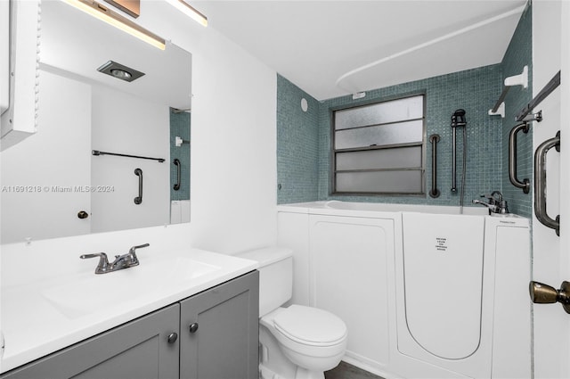 full bathroom featuring vanity, tiled shower / bath combo, and toilet