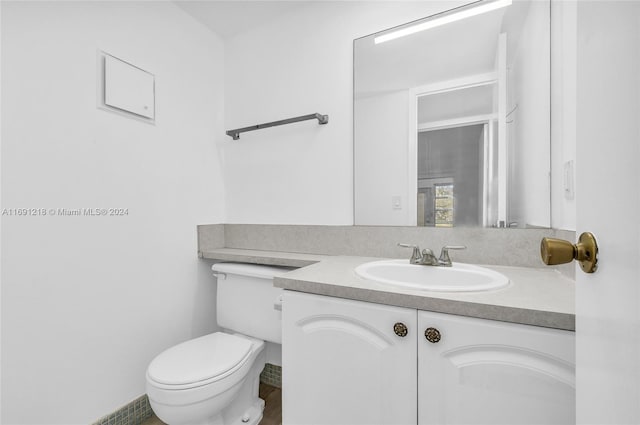 bathroom featuring toilet and vanity