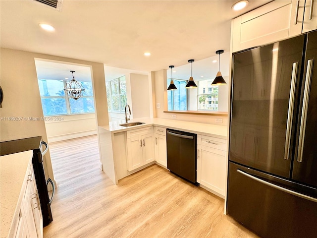 kitchen featuring sink, fridge, white cabinets, pendant lighting, and dishwasher