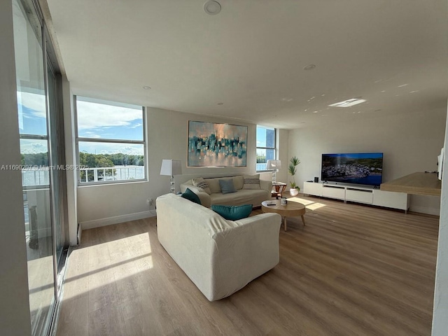 16546 NE 26th Ave Unit 3G, North Miami Beach, FL 33160 - living room with wood finished floors and baseboards