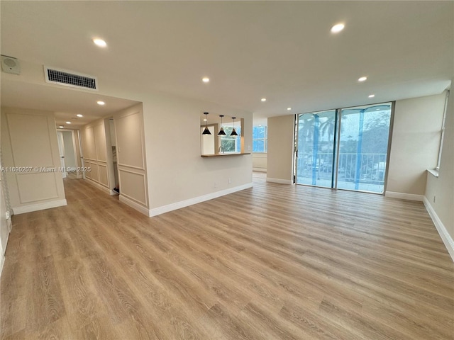 16546 NE 26th Ave Unit 3G, North Miami Beach, FL 33160 - unfurnished living room featuring light wood-style floors and recessed lighting