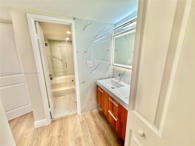 bathroom featuring hardwood / wood-style flooring, vanity, and shower / bath combination