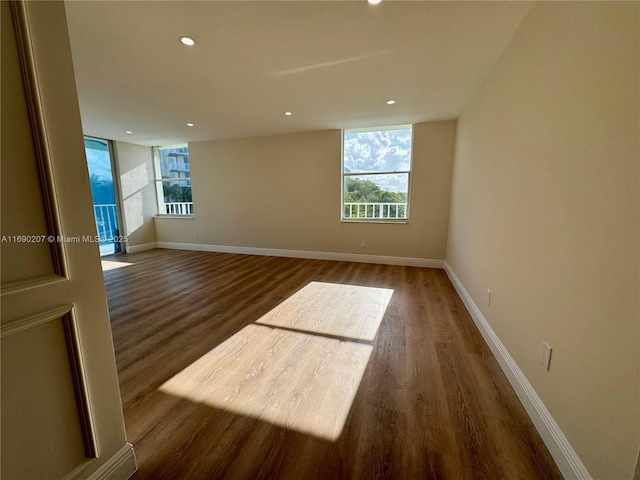 16546 NE 26th Ave Unit 3G, North Miami Beach, FL 33160 - empty room featuring wood finished floors, plenty of natural light, and recessed lighting